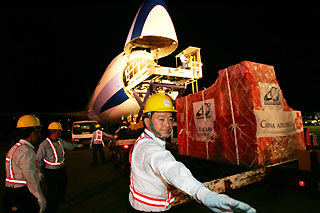 Airport workers load up a cargo plane from China Airlines, Taiwan¨s largest air carrier, at Taiwan¨s international airport in Taipei July 19, 2006.